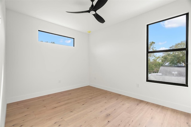 empty room featuring ceiling fan and light wood-type flooring