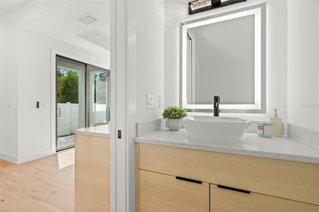 bathroom featuring wood-type flooring and vanity