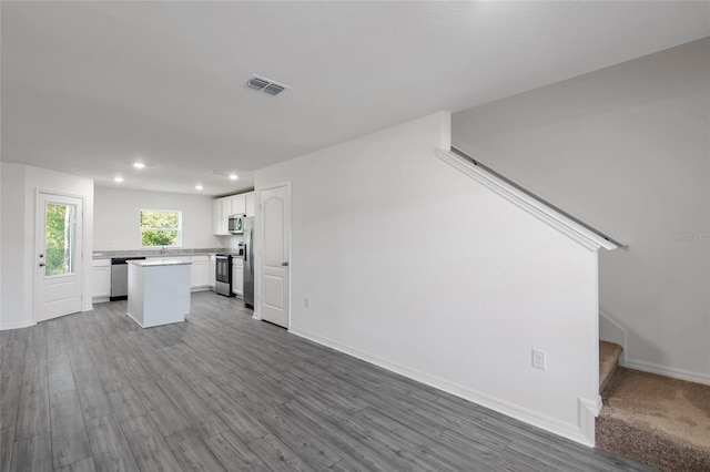 unfurnished living room featuring hardwood / wood-style flooring