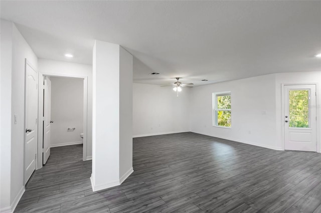 unfurnished room with ceiling fan and dark hardwood / wood-style flooring