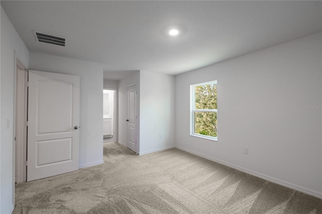 unfurnished room with light carpet