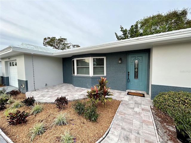 doorway to property with a garage