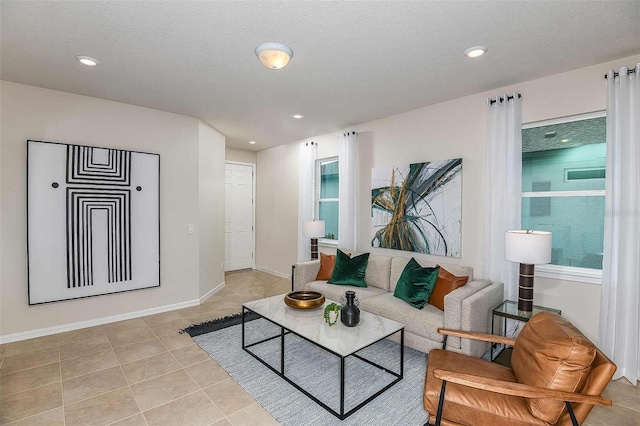 living room featuring light tile patterned floors and a textured ceiling