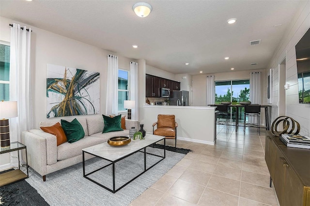 living room featuring light tile patterned floors and a textured ceiling