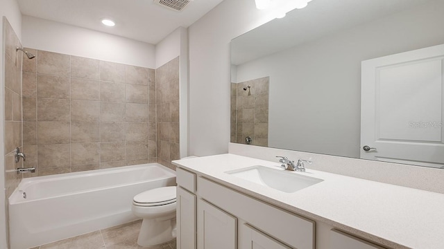 full bathroom with vanity, tiled shower / bath combo, tile patterned floors, and toilet