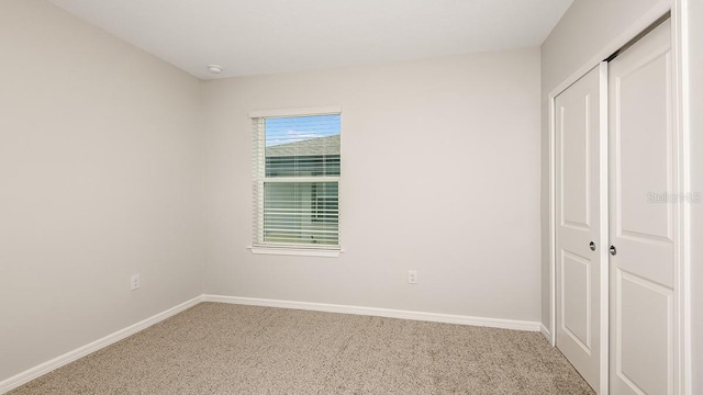 unfurnished bedroom with carpet floors and a closet