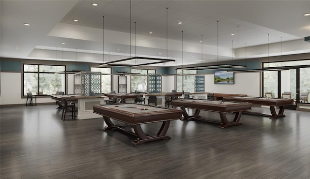 game room with pool table, dark hardwood / wood-style floors, and a raised ceiling