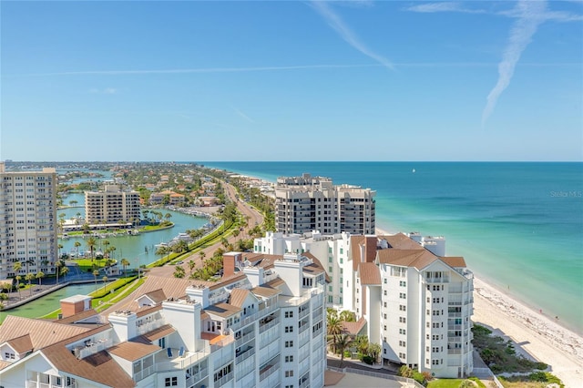 bird's eye view with a water view and a beach view