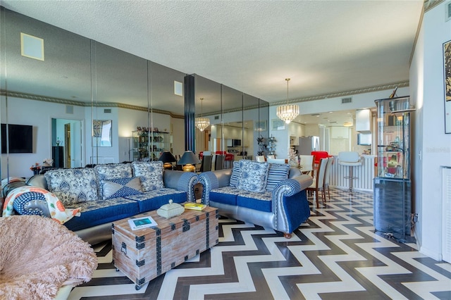 living room with a notable chandelier and a textured ceiling