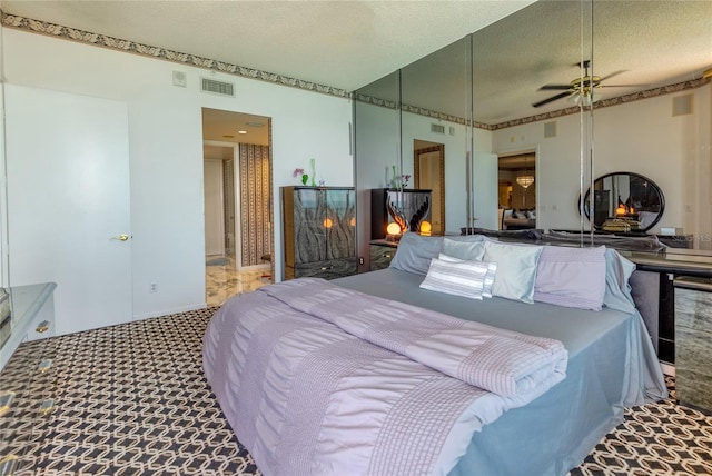 carpeted bedroom with a textured ceiling and ceiling fan