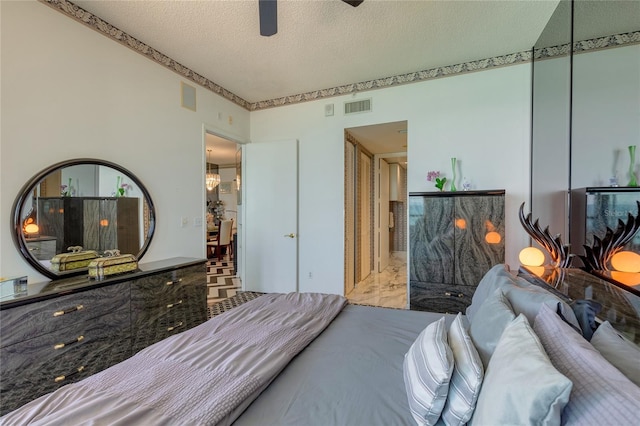 bedroom featuring a textured ceiling and ceiling fan