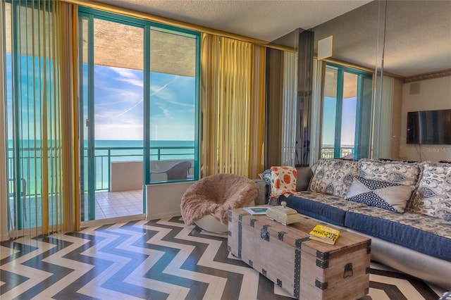 living room with a water view and a textured ceiling