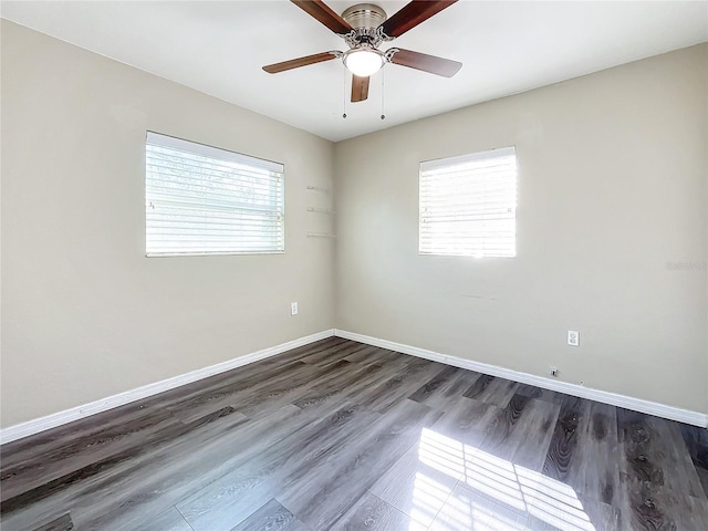 empty room with ceiling fan and dark hardwood / wood-style floors