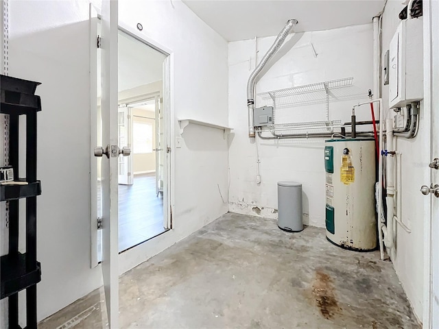 basement with electric panel and water heater