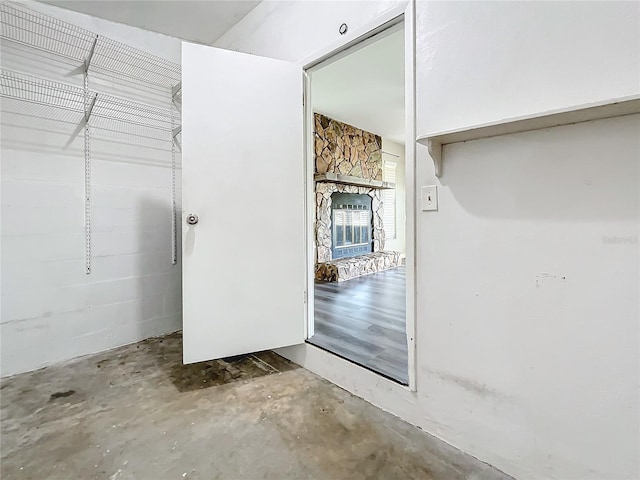 bathroom featuring concrete flooring and a fireplace