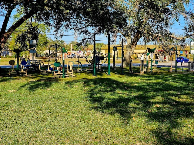 community jungle gym featuring a yard