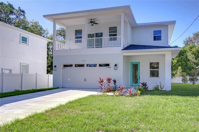 view of front facade with ceiling fan, a garage, and a front yard