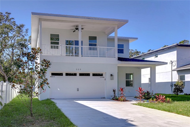 view of front of property featuring a garage, a front lawn, and ceiling fan