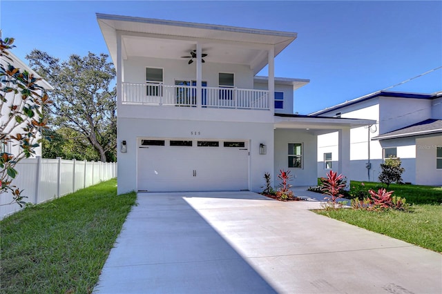 view of front of property featuring a front yard, a garage, and ceiling fan