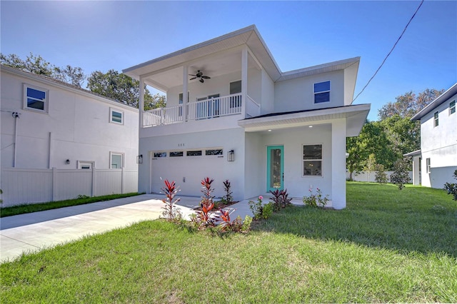 view of front facade featuring ceiling fan, a garage, and a front lawn