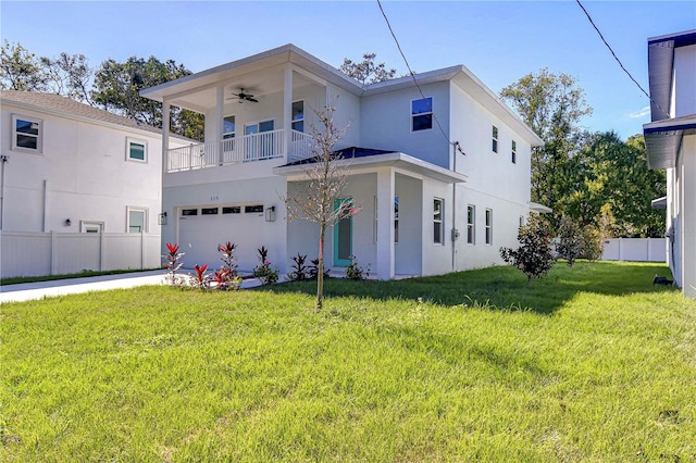 view of front of home featuring a front yard, a balcony, a garage, and ceiling fan