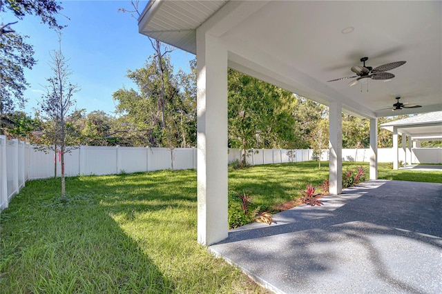 view of yard with a patio area and ceiling fan