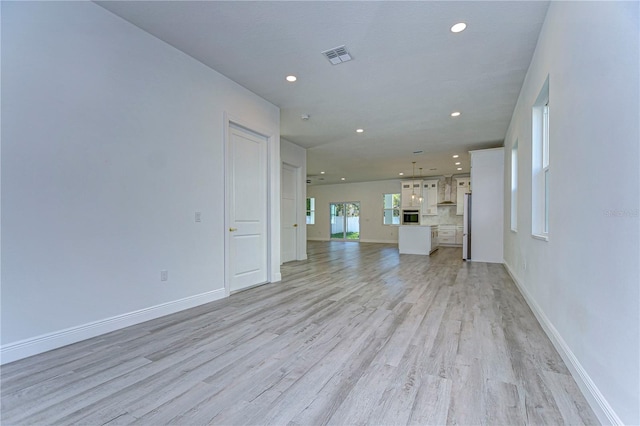 unfurnished living room featuring light hardwood / wood-style flooring