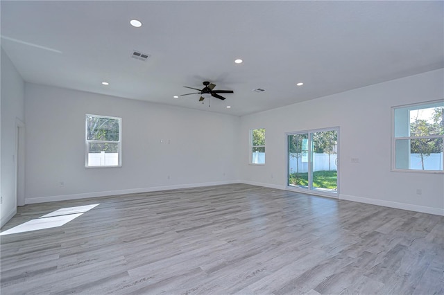 spare room with light hardwood / wood-style floors, plenty of natural light, and ceiling fan