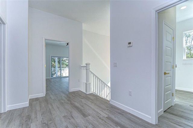 hallway featuring plenty of natural light and light wood-type flooring