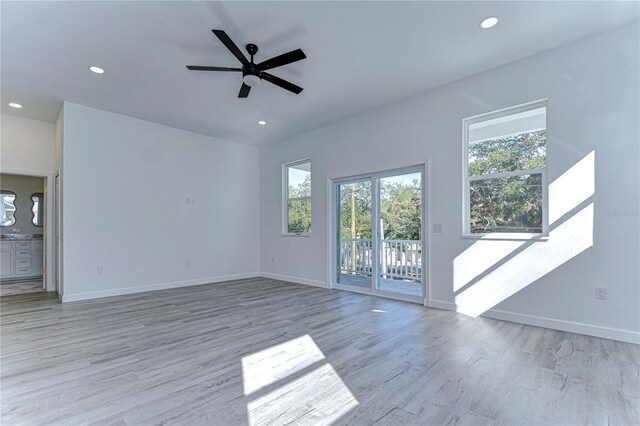 unfurnished living room with light wood-type flooring and ceiling fan