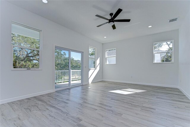 unfurnished room with plenty of natural light, light hardwood / wood-style floors, and ceiling fan