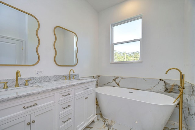 bathroom with a washtub and vanity