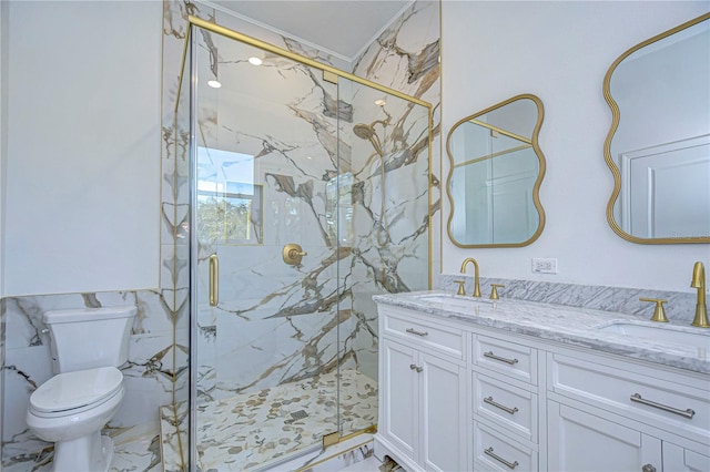 bathroom featuring vanity, toilet, and a shower with door