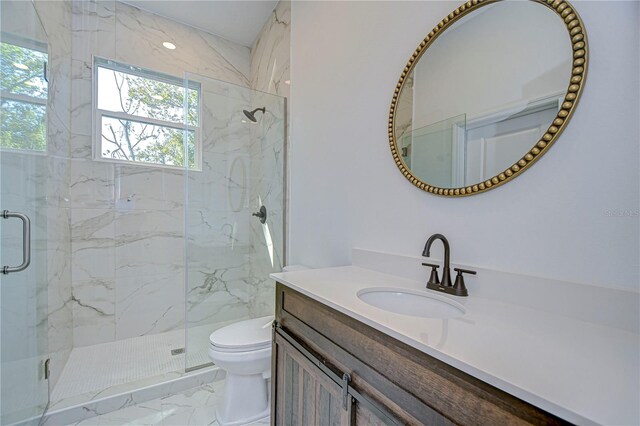 bathroom with vanity, toilet, and an enclosed shower