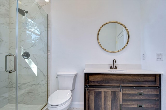 bathroom featuring vanity, toilet, and a shower with door