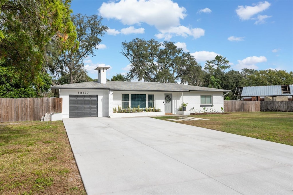 single story home with a front lawn and a garage