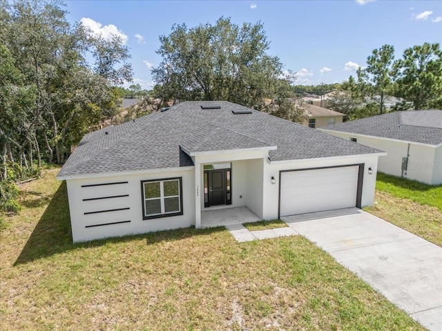 view of front of house with a front lawn and a garage