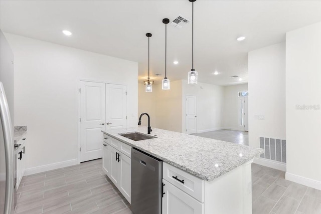 kitchen with white cabinetry, sink, stainless steel dishwasher, an island with sink, and pendant lighting