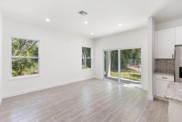 interior space featuring light hardwood / wood-style flooring and plenty of natural light