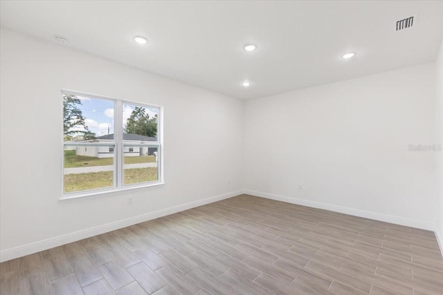 unfurnished room with light wood-type flooring