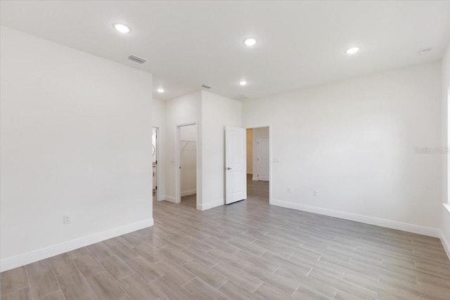 unfurnished room with light hardwood / wood-style floors