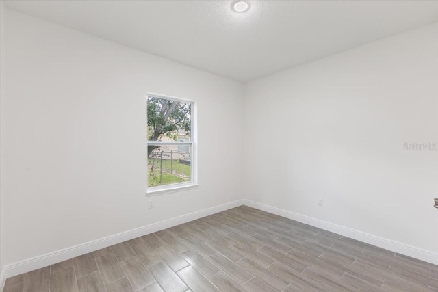 unfurnished room with light hardwood / wood-style flooring