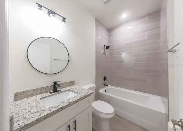 full bathroom with vanity, tiled shower / bath combo, and toilet