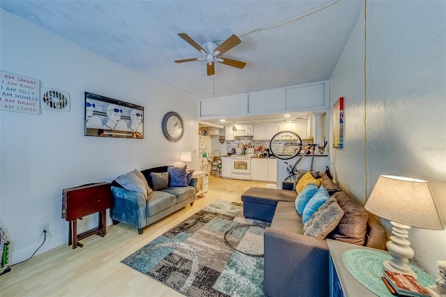 living room featuring light hardwood / wood-style flooring and ceiling fan