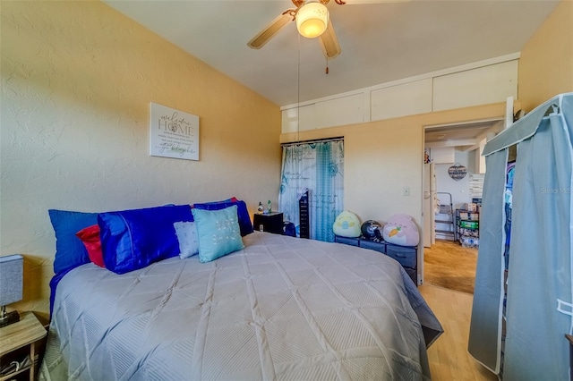 bedroom with wood-type flooring and ceiling fan