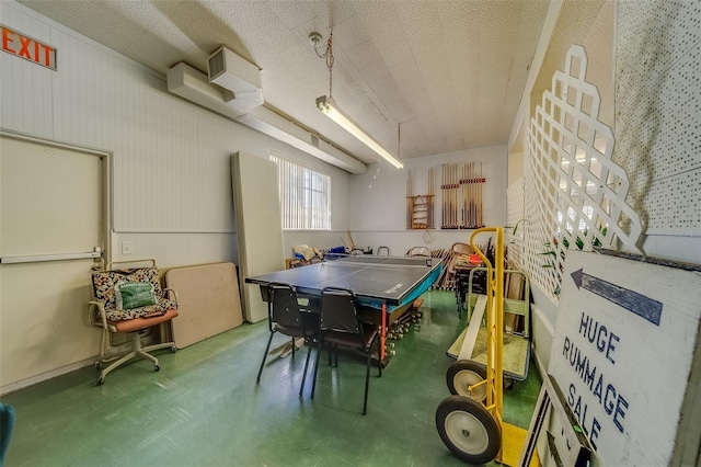 recreation room featuring concrete flooring and a textured ceiling