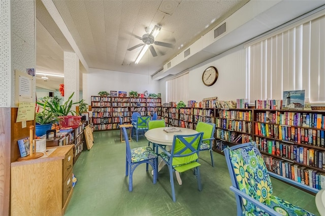 recreation room featuring ceiling fan and a textured ceiling