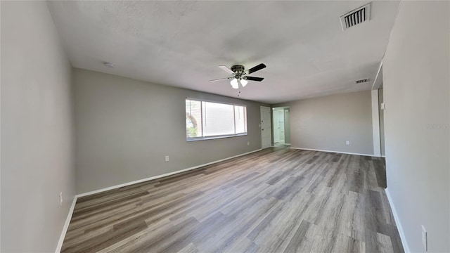 unfurnished room with ceiling fan and light wood-type flooring