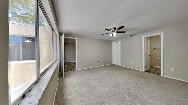 carpeted spare room with ceiling fan