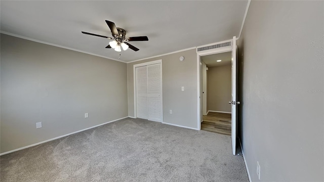 unfurnished bedroom with ceiling fan, light colored carpet, ornamental molding, and a closet